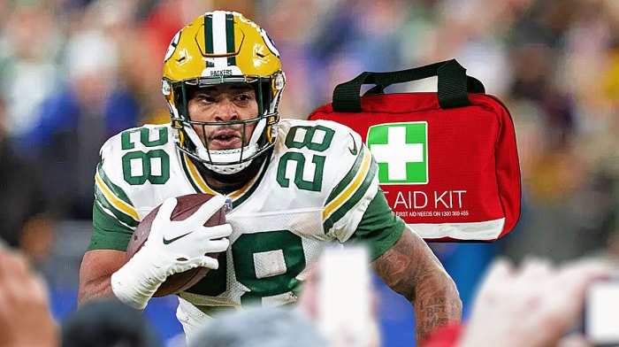 Photo: AJ Dillon in action in Packers jersey, medical kit beside him