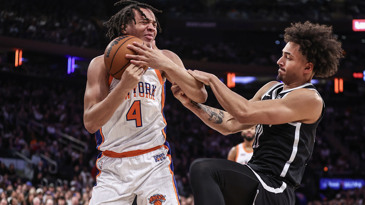 New York Knicks Guard Pacome Dadiet (4) and Brooklyn Networks Net Jalen Wilson (22) Are fighting a loose ball in the fourth quarter in Madison Square Garden