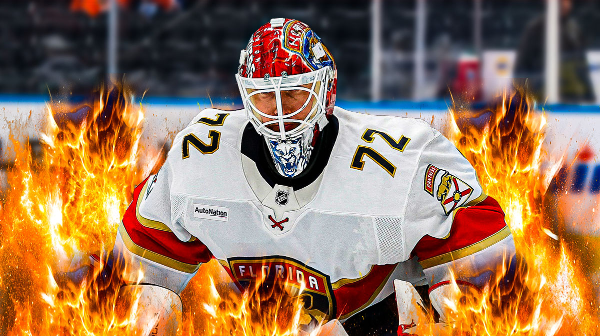 Sergei Bobrovsky looking happy with fire around him, hockey rink in background