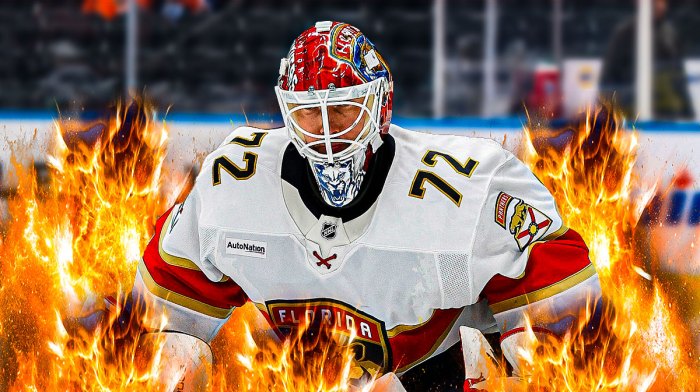 Sergei Bobrovsky looking happy with fire around him, hockey rink in background