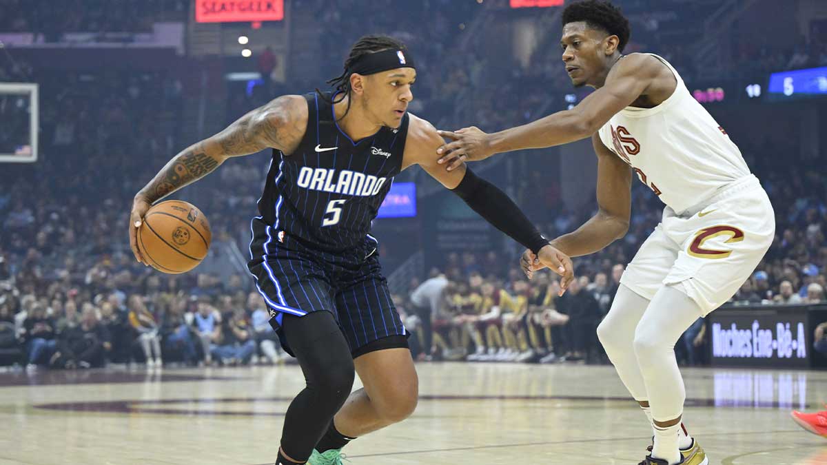 Orlando Magic forward Paolo Banchero (5) dribbles beside Cleveland Cavaliers forward De'Andre Hunter (12) in the first quarter at Rocket Arena.