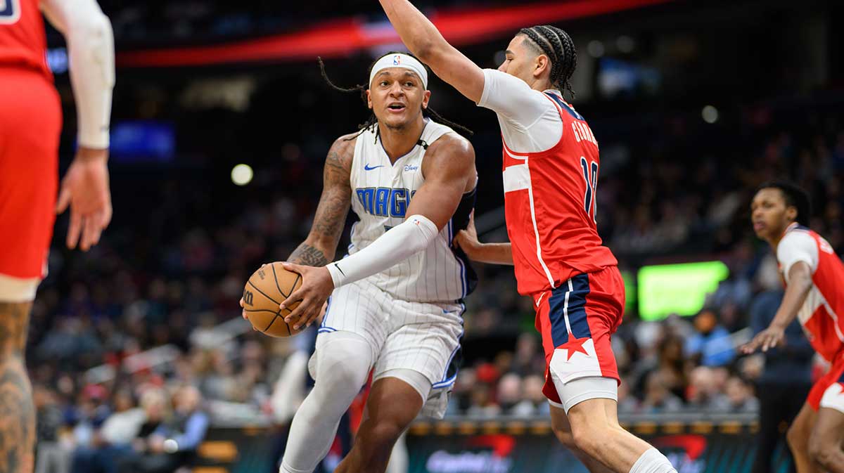 Orlando Magic forward Paolo Banchero (5) drives to the basket against Washington Wizards forward Kyshawn George (18) during the second quarter at Capital One Arena.