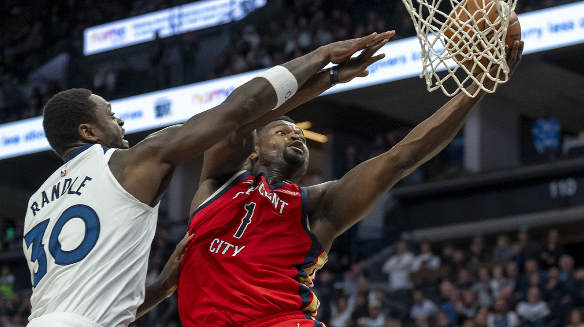 Pelicans forward Zion Williamson (1) drives to the basket past Minnesota Timberwolves forward Julius Randle