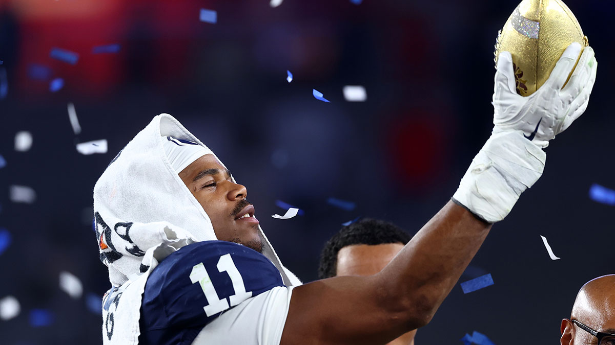 Penn State Nittany Lions defensive end Abdul Carter (11) reacts with the trophy after the game against the Boise State Broncos in the Fiesta Bowl at State Farm Stadium.