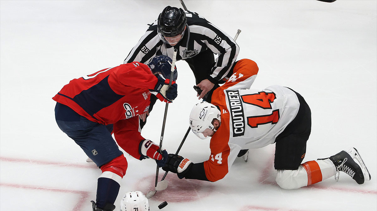 Washington Capitals center Lars Eller (20) and Philadelphia Flyers center Sean Couturier (14) face off during the second period at Capital One Arena.