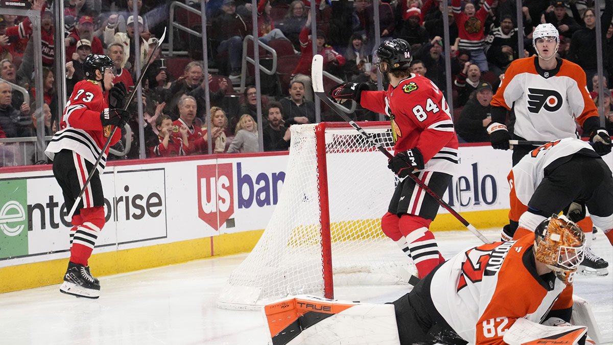 Chicago Blackhawks left wing Lukas Reichel (73) celebrates after his goal against the Philadelphia Flyers with left wing Landon Slaggert (84) during the third period at United Center.