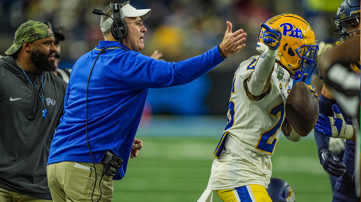 Pittsburgh Panthers head coach Pat Narduzzi hits Pittsburgh Panthers running back Juelz Goff (26) on the helmet after getting a first down, during the first half of the 2024 GameAbove Sports Bowl at Ford Field in Detroit, Thursday, Dec. 26, 2024.