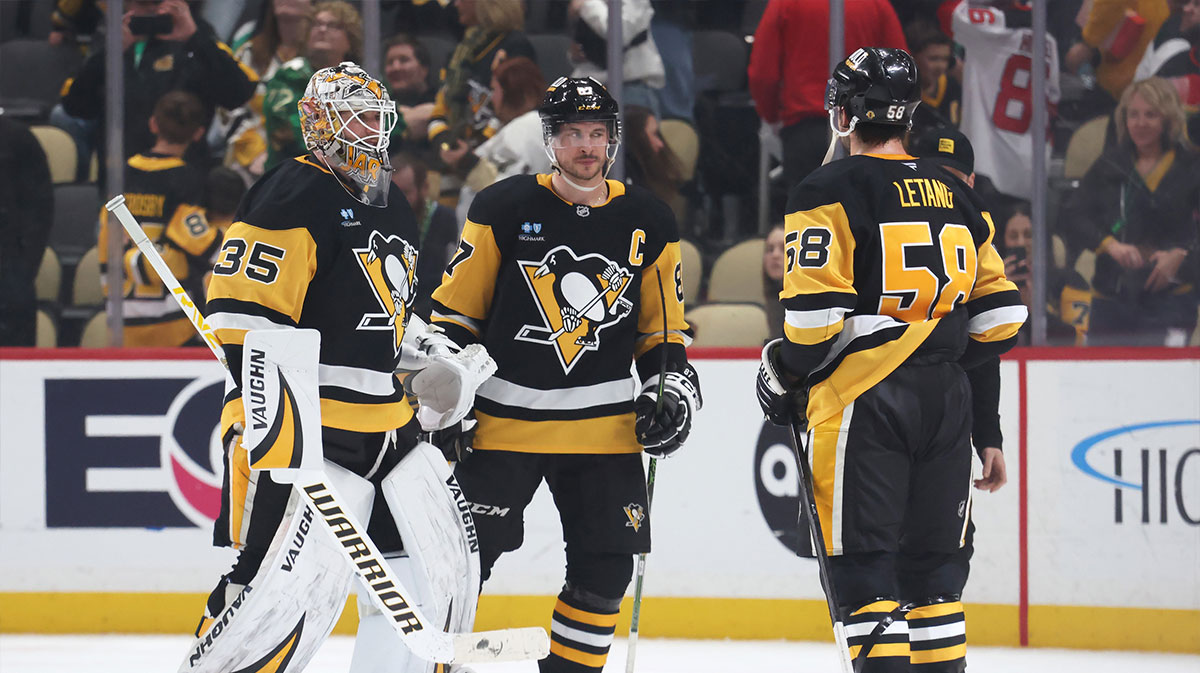 Pittsburgh Penguins goaltender Tristan Jarry (35) and center Sidney Crosby (87) and defenseman Kris Letang (58) celebrate after defeating the New Jersey Devils at PPG Paints Arena.