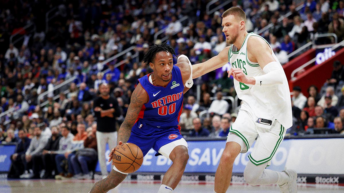 Detroit Pistons forward Ronald Holland II (00) dribbles defended by Boston Celtics center Kristaps Porzingis (8) in the second half at Little Caesars Arena. M