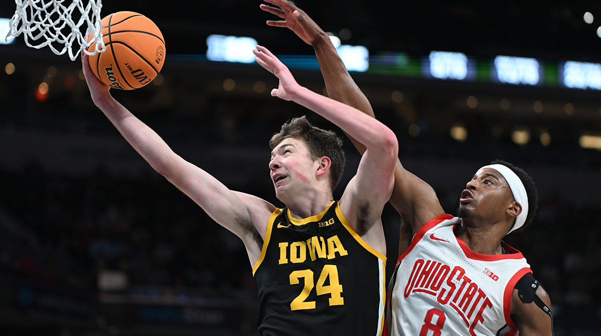 Iowa Hawkeyes basketball forward Pryce Sandfort (24) scores past Ohio State Buckeyes guard Micah Parrish (8) during the second half at Gainbridge Fieldhouse