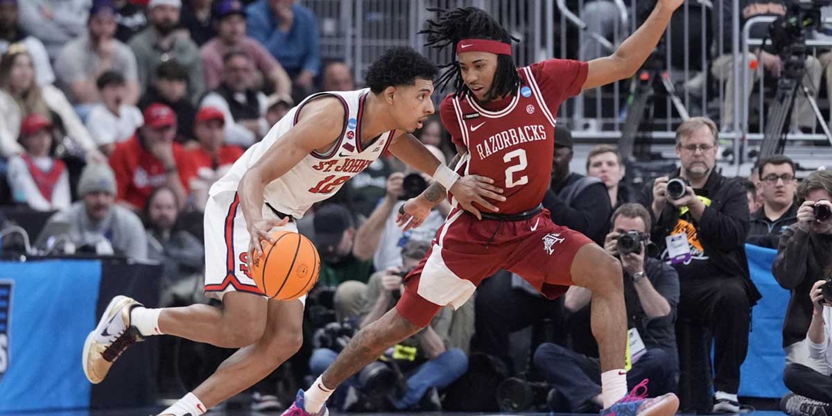 St. John's Red Storm guard RJ Luis Jr. (12) dribbles against Arkansas Razorbacks guard Boogie Fland (2) during the second half of a second round men’s NCAA Tournament game at Amica Mutual Pavilion. Mandatory Credit: Gregory Fisher-Imagn Images