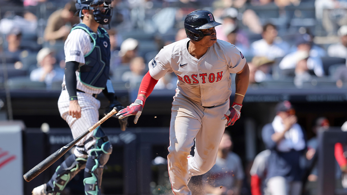 Boston Red Sox third baseman Rafael Devers (11) follows through on a two run single against the New York Yankees during the fifth inning at Yankee Stadium.