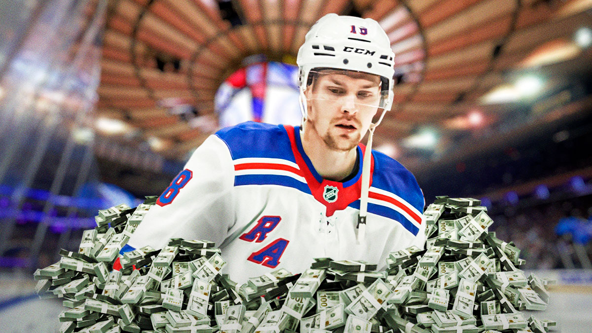 Urho Vaakanainen in image looking happy, money in image, hockey rink in background
