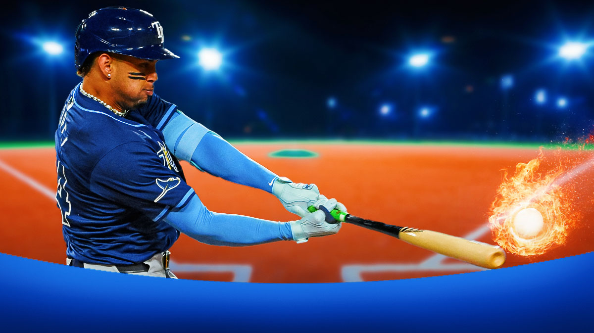 Junior Caminero hitting a baseball with flames coming off of it