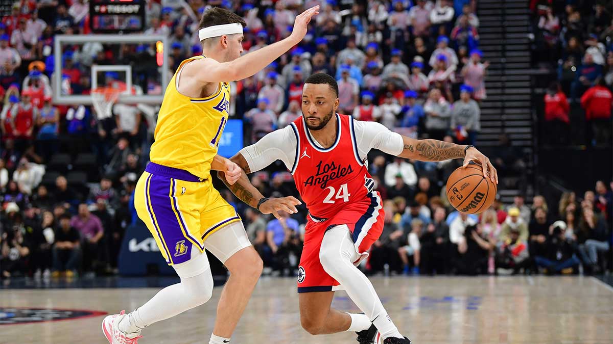  Los Angeles Clippers guard Norman Powell (24) moves the ball against Los Angeles Lakers guard Austin Reaves (15) during the first half at Intuit Dome.