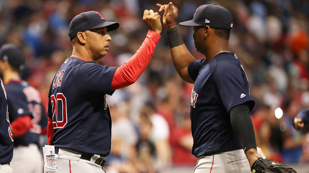Boston Red Sox manager Alex Cora (20) congratulates third baseman Rafael Devers (11) as they beat the Tampa Bay Rays at Tropicana Field.