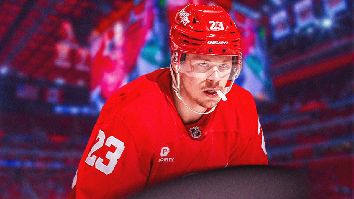Red Wings star Lucas Raymond at Little Caesars Arena with a puck in front of him.