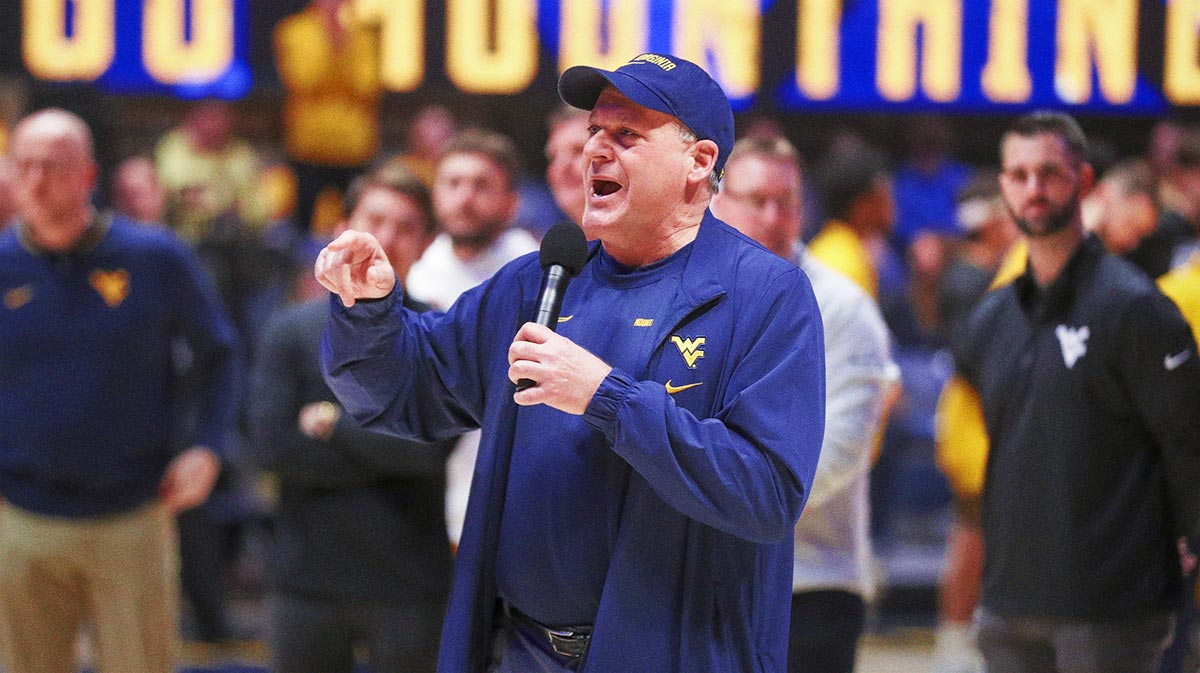 West Virginia Mountaineers head football coach Rich Rodriguez speaks to the crowd during a timeout during the first half against the Cincinnati Bearcats at WVU Coliseum.