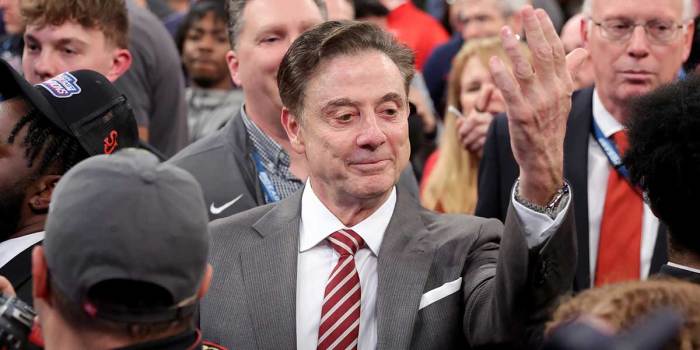 St. John's head coach Rick Pitino gestures towards campus minister for athletics Richard Rock (not pictured) to down the net after defeating the Creighton Bluejays to win the Big East Tournament at Madison Square Garden.
