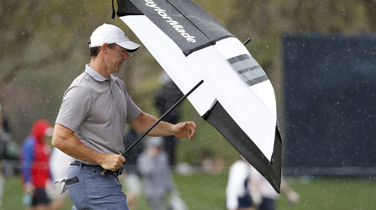 Rory McIlroy heads back to the clubhouse from the twelfth fairway after the horn blew for inclement weather during the final round of The Players Championship golf tournament at TPC Sawgrass