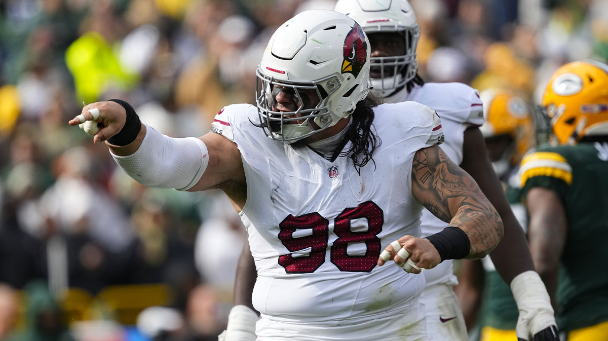 Oct 13, 2024; Green Bay, Wisconsin, USA; Arizona Cardinals defensive tackle Roy Lopez (98) celebrates following a tackle during the third quarter against the Green Bay Packers at Lambeau Field.