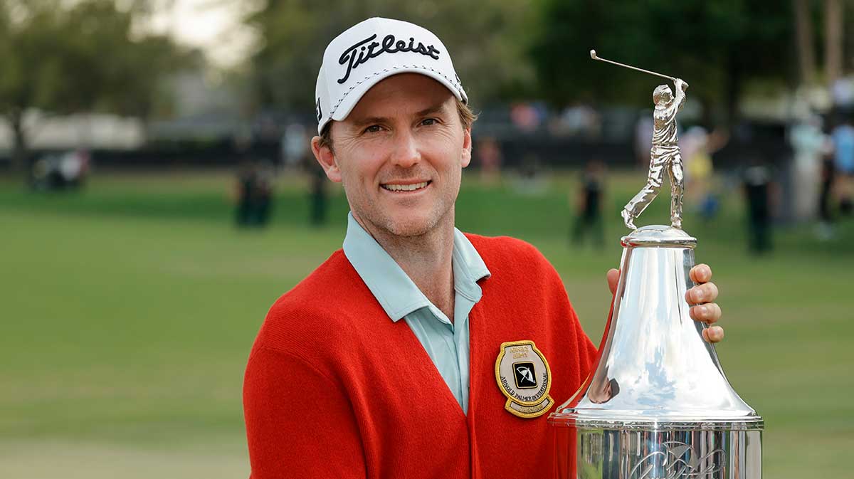 Russell Henley holds the champions trophy after winning the Arnold Palmer Invitational golf tournament at Bay Hill. 