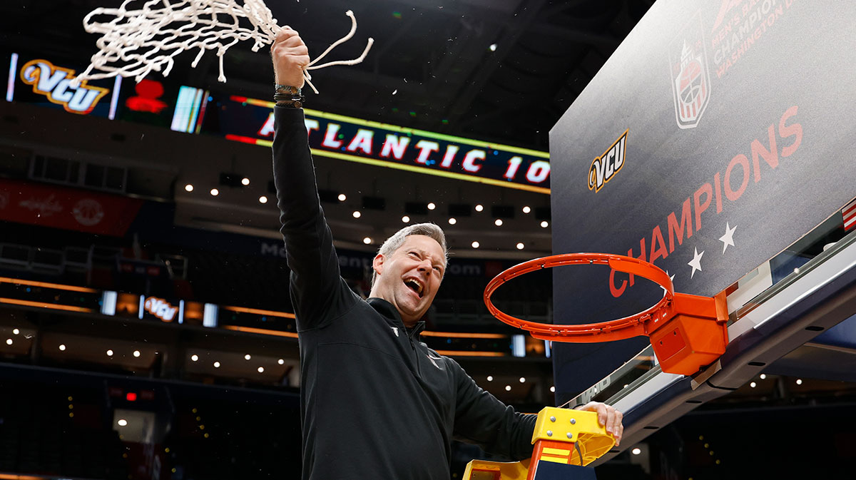 VCU Rams head coach Ryan Odom celebrates after cutting down the net during the championship trophy ceremony after the Rams game against the George Mason Patriots at Capital One Arena.