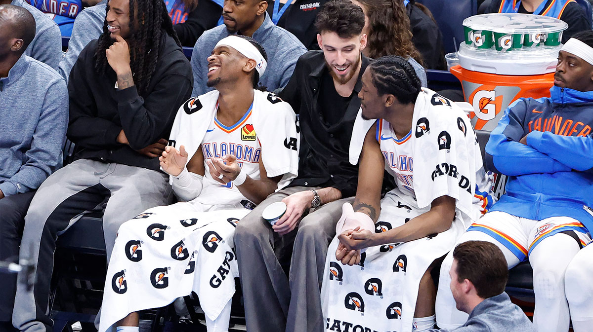 Oklahoma City Thunder guard Cason Wallace (22), guard Shai Gilgeous-Alexander (2), forward Chet Holmgren (7) and forward Jalen Williams (8) watch the game against the Phoenix Suns from the bench during the fourth quarter of a game at Paycom Center.