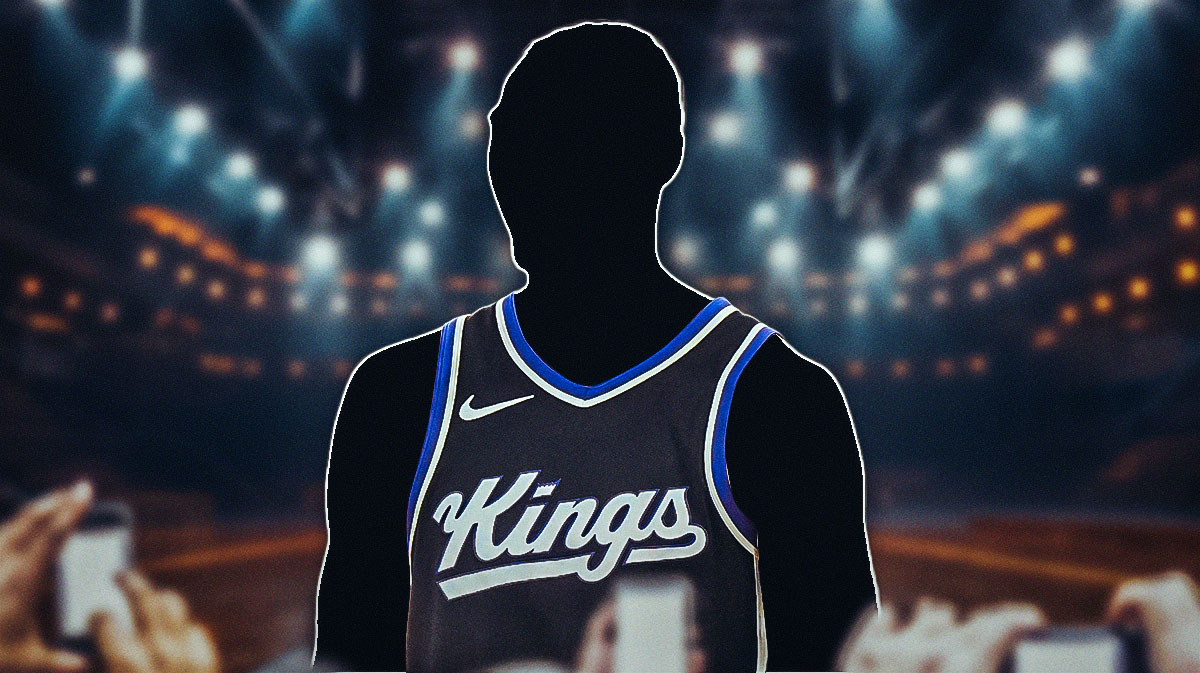 A shadowy player in a Sacramento Kings jersey with the Kings arena in the background Isaac Jones roster move