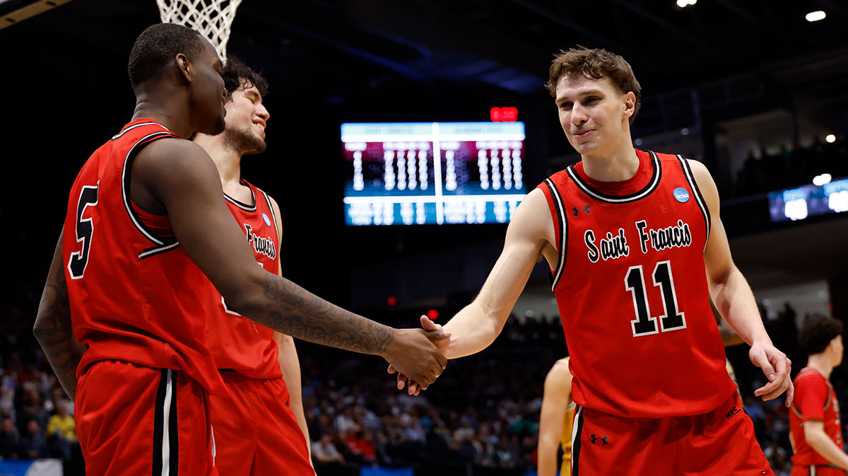 St. Francis (Pa) Red Flash guard Daemar Kelly (5) celebrates a play with guard Riley Parker (11) in the second half against the Alabama State Hornets at UD Arena.