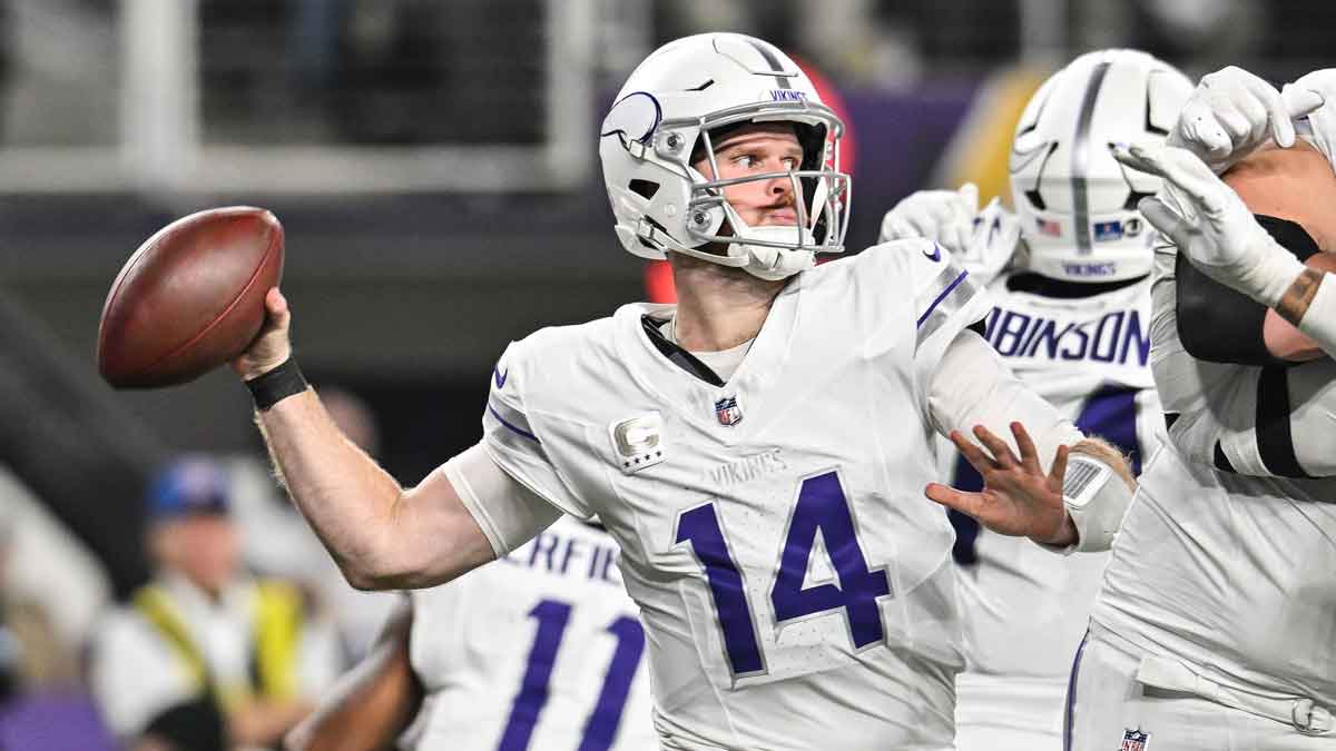 Dec 16, 2024; Minneapolis, Minnesota, USA; Minnesota Vikings quarterback Sam Darnold (14) throws a pass against the Chicago Bears during the third quarter at U.S. Bank Stadium.