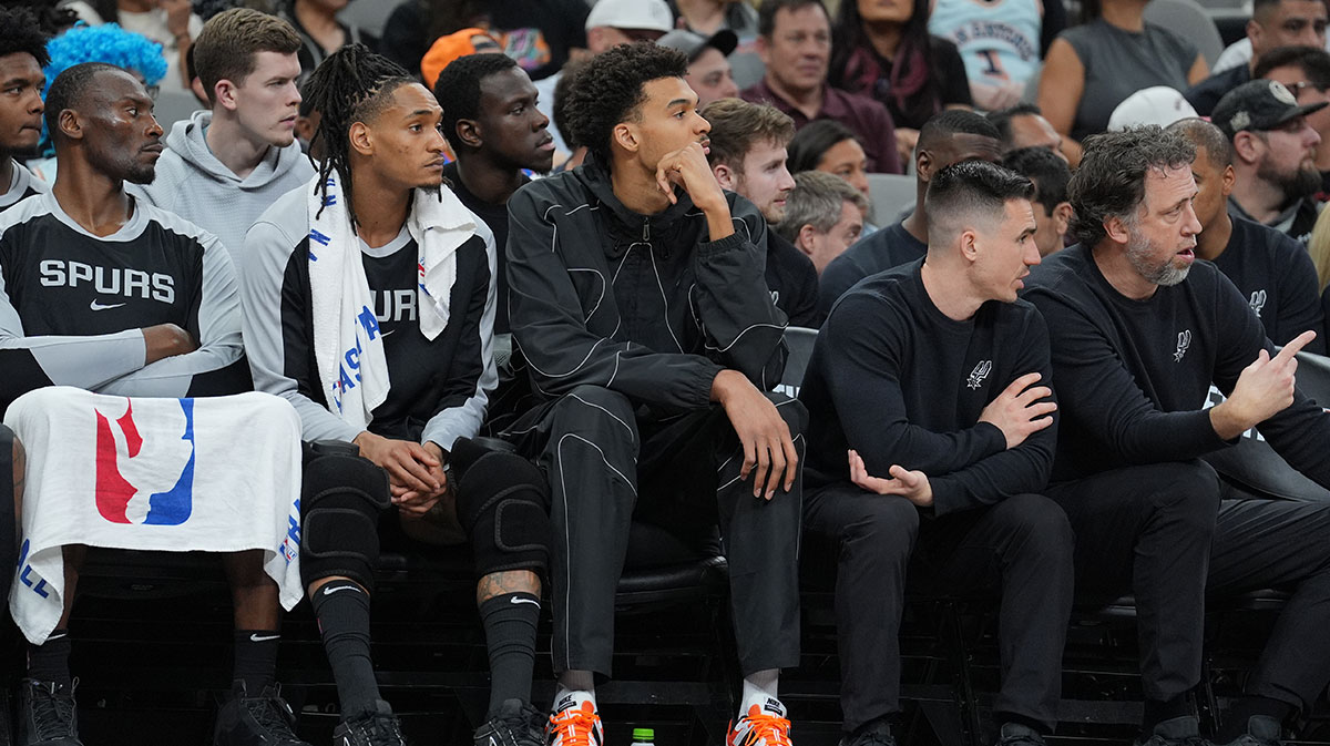 The center of San Antonio Spurs, Victor Wembanyama (1) observes from the bank in the first half against the Oklahoma City Thunder in Frost Bank Center. 