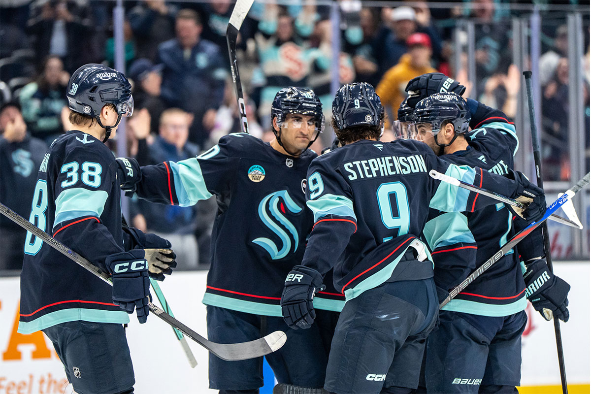 Seattle Kraken, from left, forward Jani Nyman (38), forward Matty Beniers (10), forward Chandler Stephenson (9) and forward Jordan Eberle (7) celebrate a goald during the third period against the Montreal Canadiens at Climate Pledge Arena.