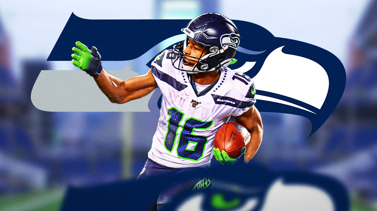 Seahawks Tyler Lockett looking up with Seattle Seahawks tribute logo in background