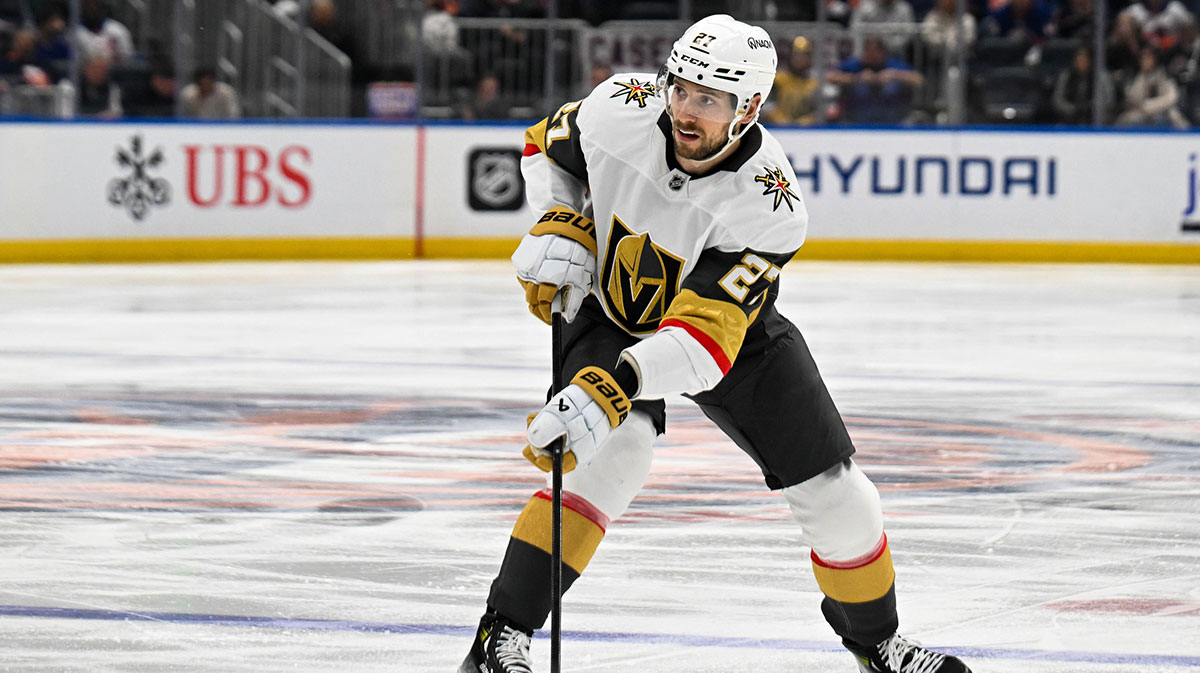 Vegas Golden Knights defenseman Shea Theodore (27) skates with the puck against the New York Islanders during the third period at UBS Arena. 
