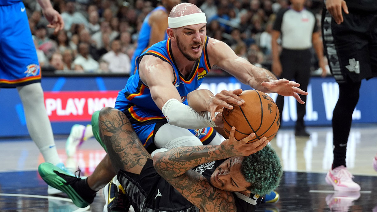 Spurs Forward Jeremi Soci (10) and Oklahoma City Garge Guard Alex Caruso (9) Battle