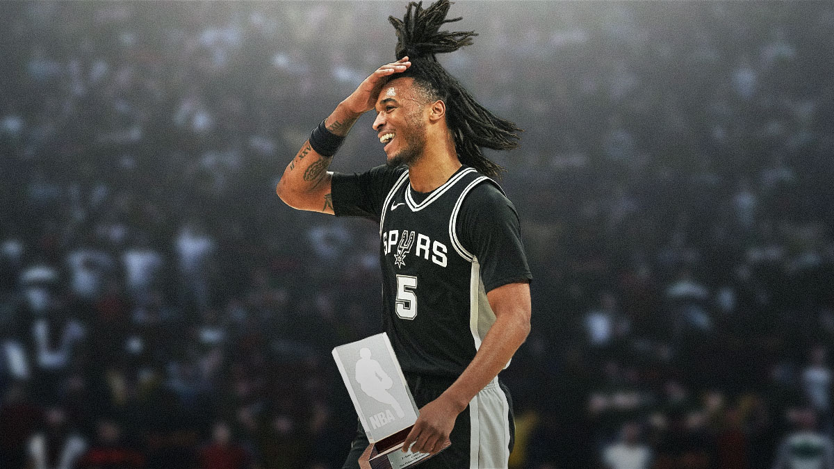 Spurs' Stephon Castle holding the Rookie of the Year trophy