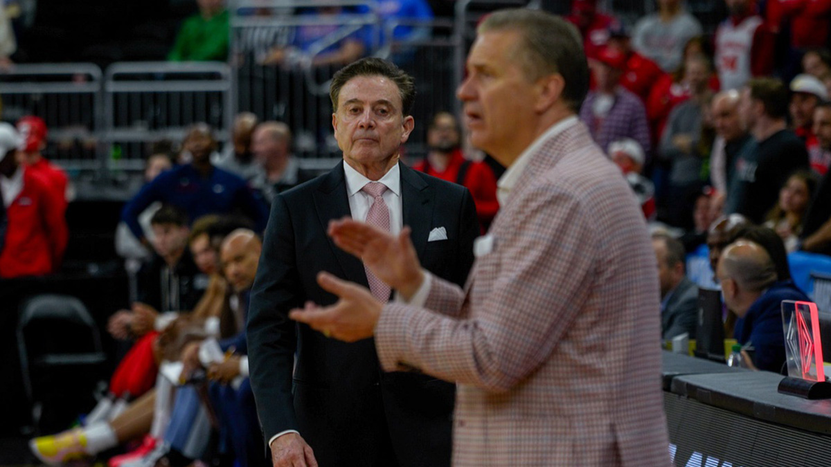 Coach Rick Pitino, left, approaches Coach John Calipari as their March Madness game is about to end on Saturday.
