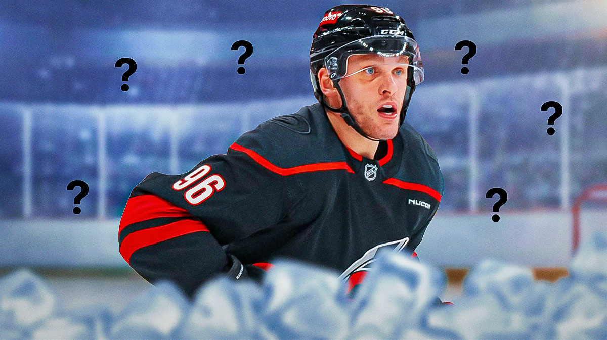 Mikko Rantanen (Carolina Hurricanes) looking stern with question marks around him, hockey rink in background