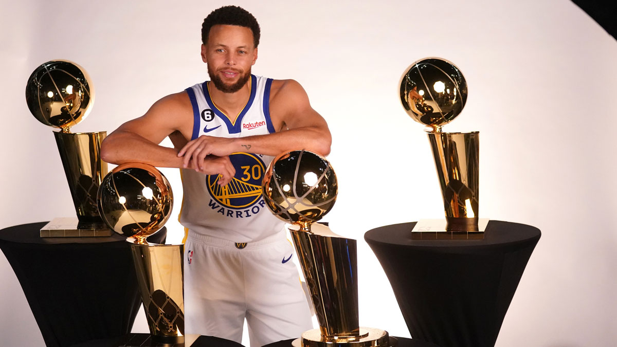 Golden State Warriors guard Stephen Curry (30) poses with the Larry O'Brien Championship Trophies during Media Day at the Chase Center.