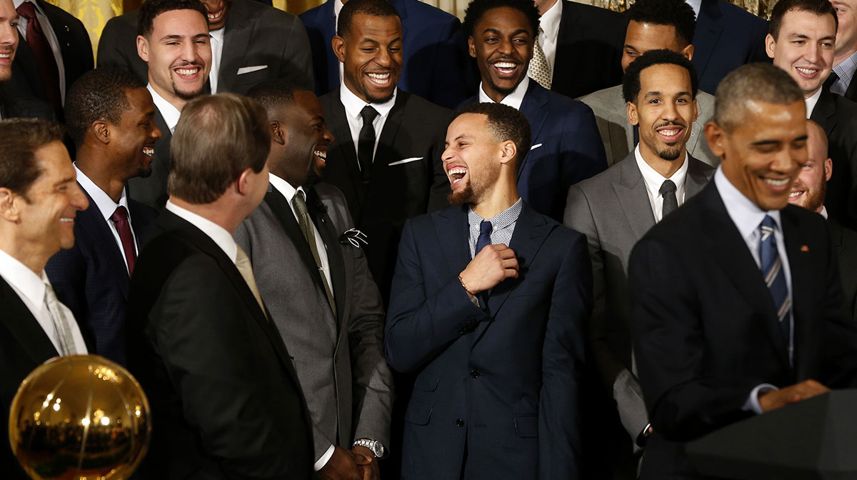 Golden State Warriors guard Stephen Curry (M) laughs with teammates as President Barack Obama (R) speaks during a ceremony honoring the 2015 NBA Champion Warriors in the East Room at the White House.