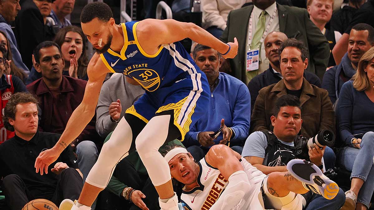 Golden State Warriors guard Stephen Curry (30) gathers the ball above Denver Nuggets forward Aaron Gordon (32) during the second quarter at Chase Center. 