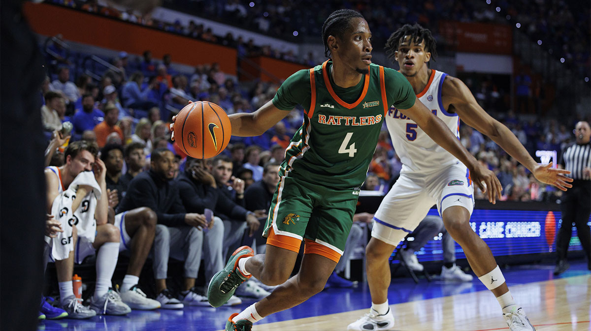 Florida A&M Rattlers guard Sterling Young (4) dribbles the ball past Florida Gators guard Will Richer (5) during the first half at Exactech Arena at the Stephen C. O'Connell Center.