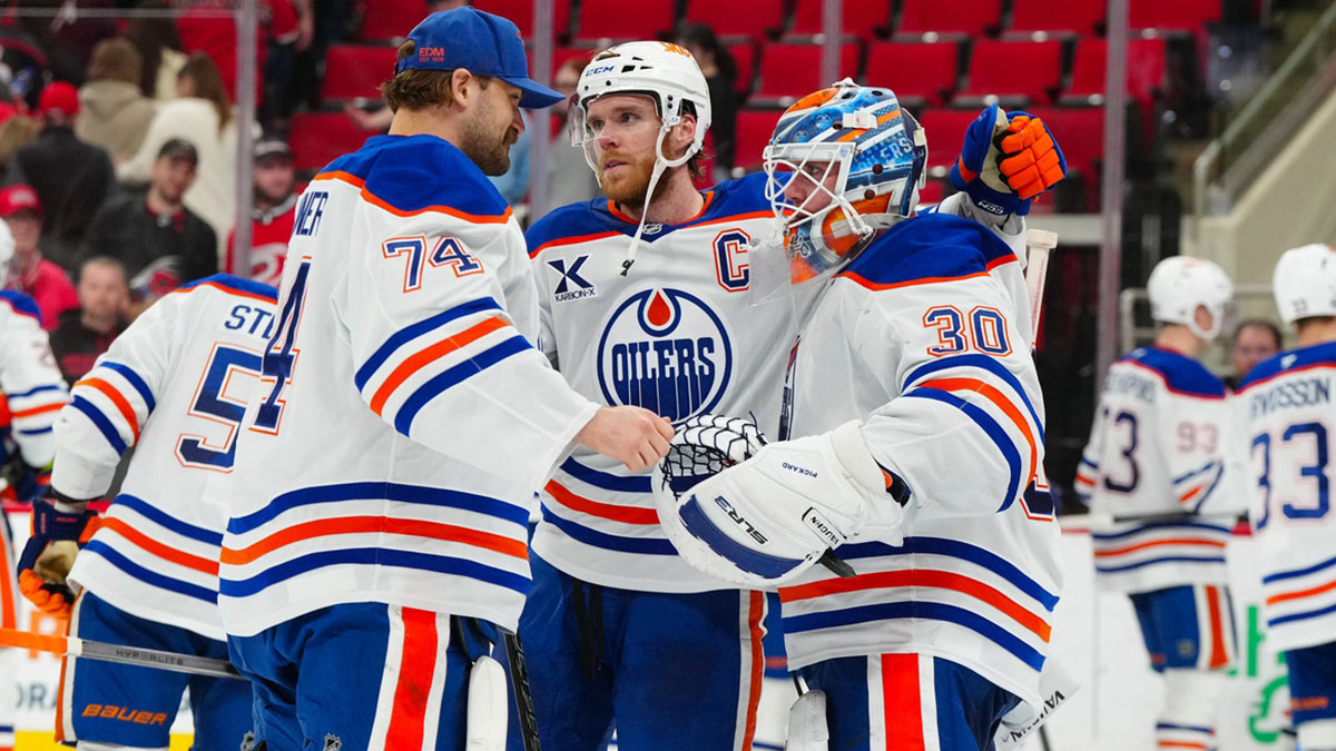 Edmonton Oilers goaltender Calvin Pickard (30) celebrate their victory with center Connor McDavid (97) and goaltender Stuart Skinner (74) against the Carolina Hurricanes at Lenovo Center.