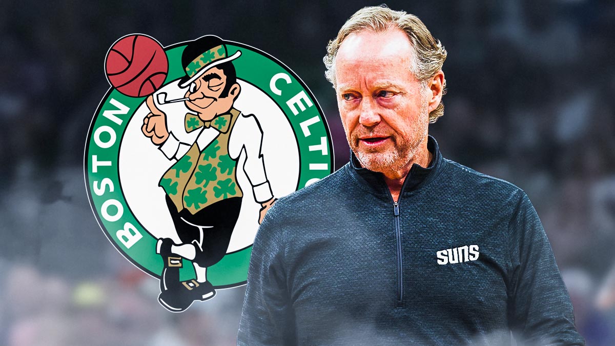 Mike Budenholzer with his head down, and the Celtics logo next to him, and the Suns home arena in the background.