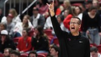 TCU women's basketball coach Mark Campbell instructs his team against Texas Tech in a Big 12 women's basketball game.
