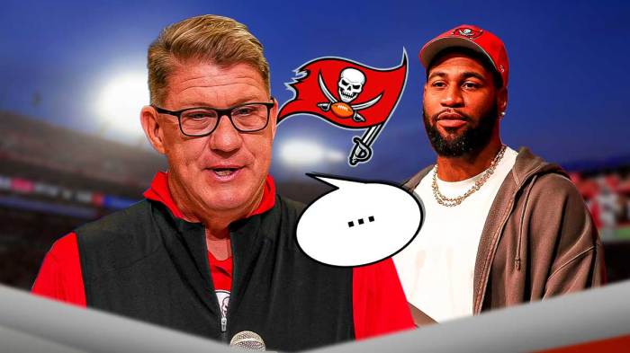 Buccaneers logo behind GM Jason Licht with speech bubble above his head looking at Haason Reddick after signing him in free agency. Background is Raymond James Stadium.