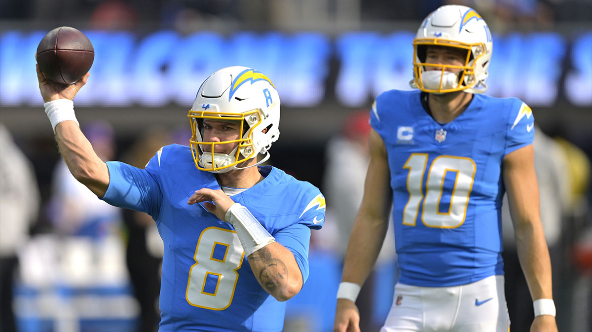 Los Angeles Chargers quarterback Justin Herbert (10) looks on as quarterback Taylor Heinicke (8) warms up prior to the game against the Tampa Bay Buccaneers at SoFi Stadium.