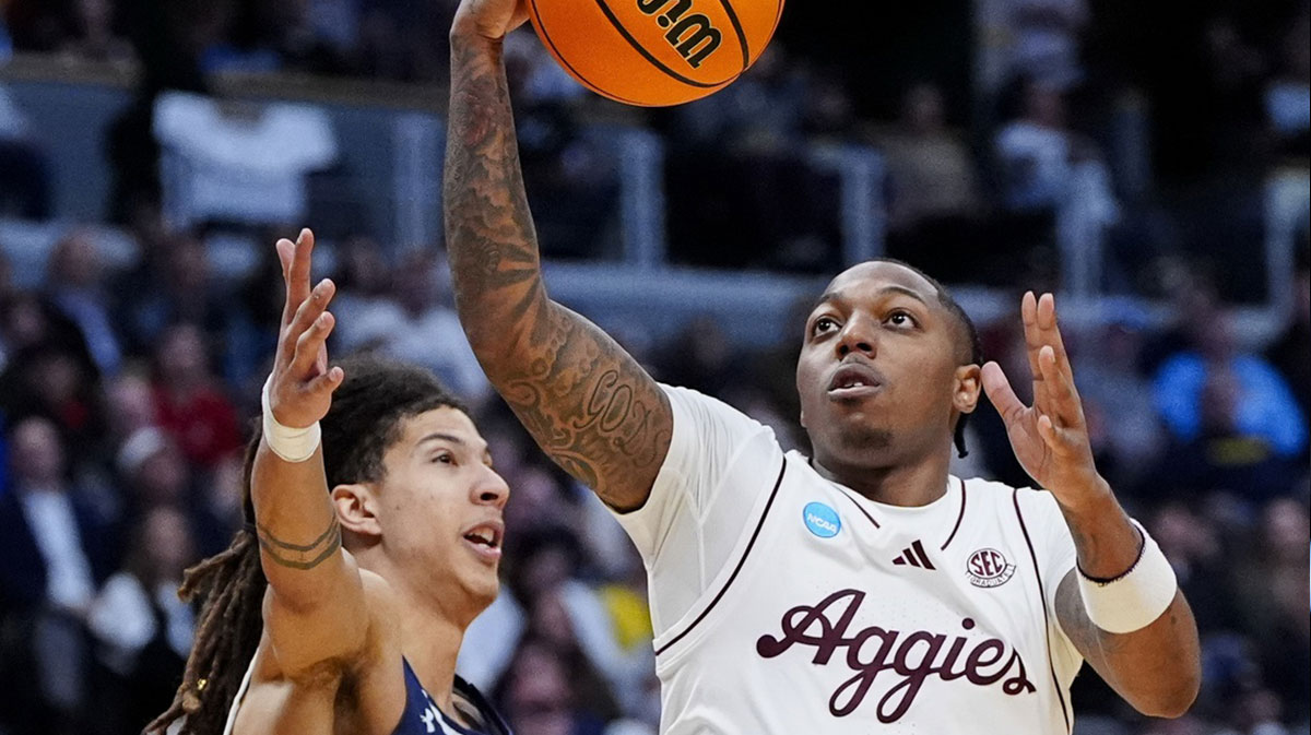 Texas A&M Aggies guard Wade Taylor IV (4) drives as Yale Bulldogs forward Casey Simmons (14) defends during the second half at Ball Arena.