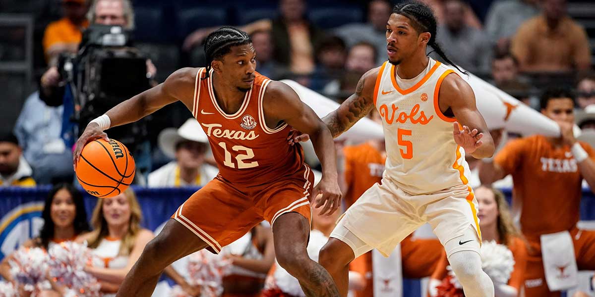 Texas guard Tramon Mark (12) looks for an opening against Tennessee guard Zakai Zeigler (5) during the second half of a Southeastern Conference tournament quarterfinal game at Bridgestone Arena in Nashville, Tenn., Friday, March 14, 2025.
